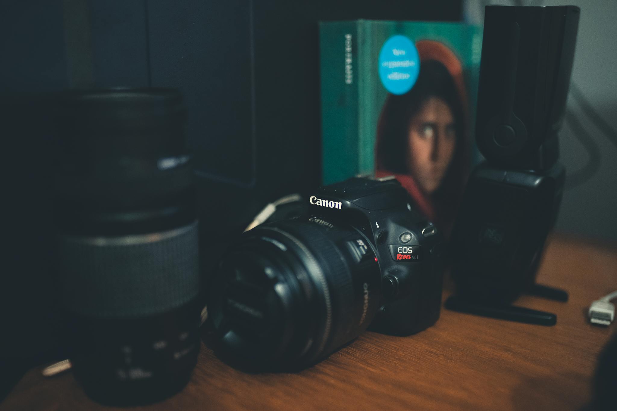 Photo camera with professional equipment on table